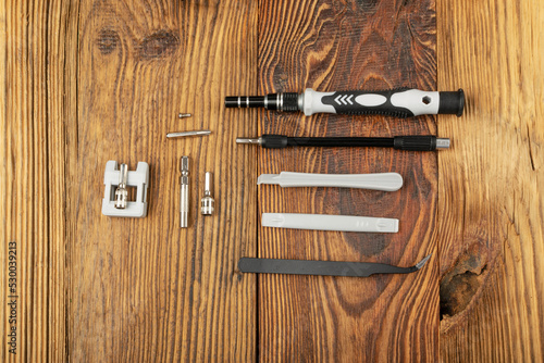 Phone Repair Tools on Wooden Table, Repair Tool Collection
