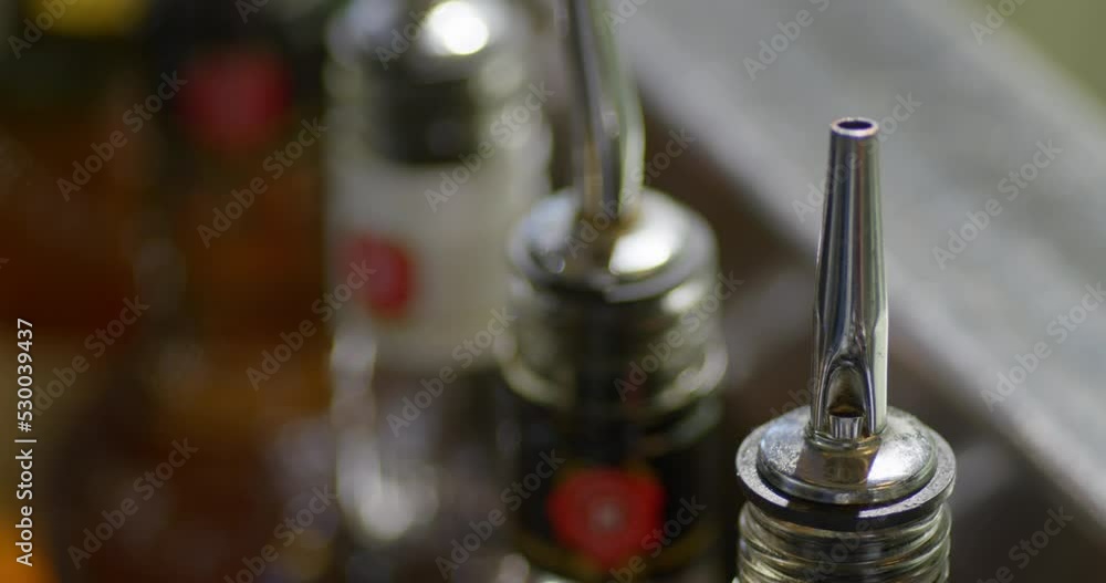 Bottles at the bar with cocktail pourer. Bottles at the bar with cocktail pourer.