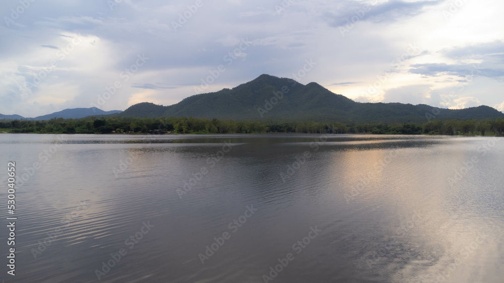 Aerial view of reservoir on tropical mountain background at sunset in northern Thailand. Beautiful landscape nature background.