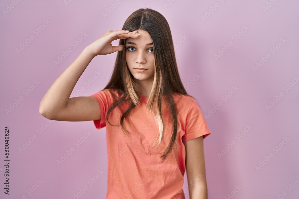 Teenager girl standing over pink background worried and stressed about a problem with hand on forehead, nervous and anxious for crisis Teenager girl standing over pink background worried and stressed about a problem with hand on forehead, nervous and anxious for crisis