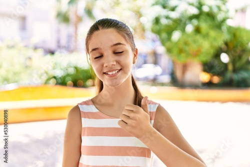 Young teenager girl outdoors on a sunny day smiling happy and positive, thumb up doing excellent and approval sign Free Download Young teenager girl outdoors on a sunny day smiling happy and positive, thumb up doing excellent and approval sign - GFXLoad