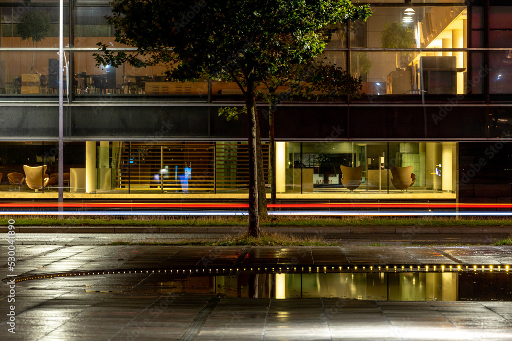 Fototapeta premium Copenhagen, Denmark Car streaks at night on Kalvebod Brygge in downtown.also known as the Under krystallen plaza.