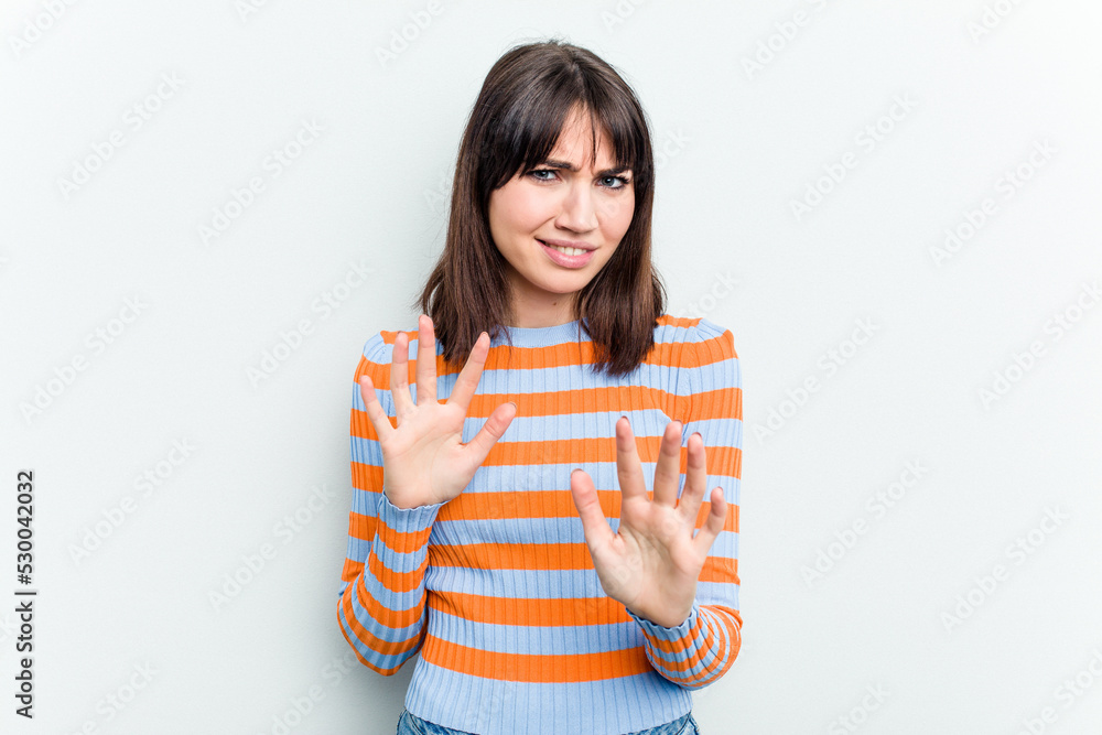 Young caucasian woman isolated on white background rejecting someone showing a gesture of disgust. Young caucasian woman isolated on white background rejecting someone showing a gesture of disgust.