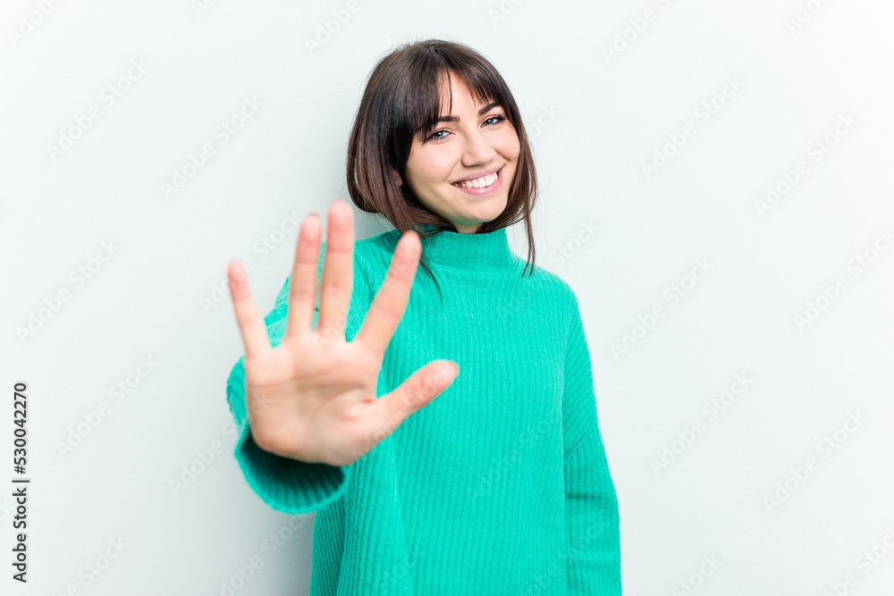 Young caucasian woman isolated on white background smiling cheerful showing number five with fingers. Young caucasian woman isolated on white background smiling cheerful showing number five with fingers.