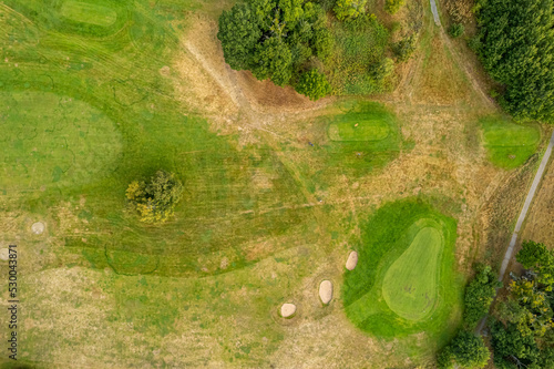 Sweden, Knislinge – September 10, 2022: Aerial view of a little village, golf course, green field photo