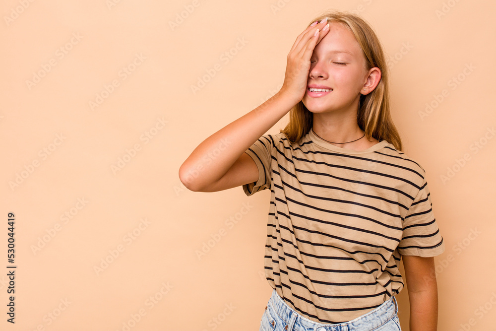 Caucasian teen girl isolated on beige background laughing happy, carefree, natural emotion. Caucasian teen girl isolated on beige background laughing happy, carefree, natural emotion.
