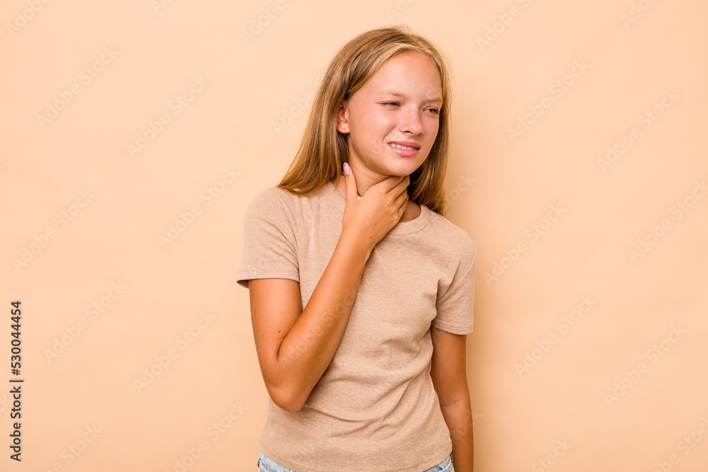 Fototapeta premium Caucasian teen girl isolated on beige background suffers pain in throat due a virus or infection.