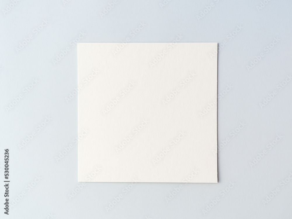 empty square cardboard sheet on a on a blue background. empty space for text empty square cardboard sheet on a on a blue background. empty space for text