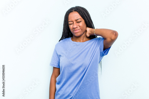 Young African American woman with braids hair isolated on blue background suffering neck pain due to sedentary lifestyle. © Asier