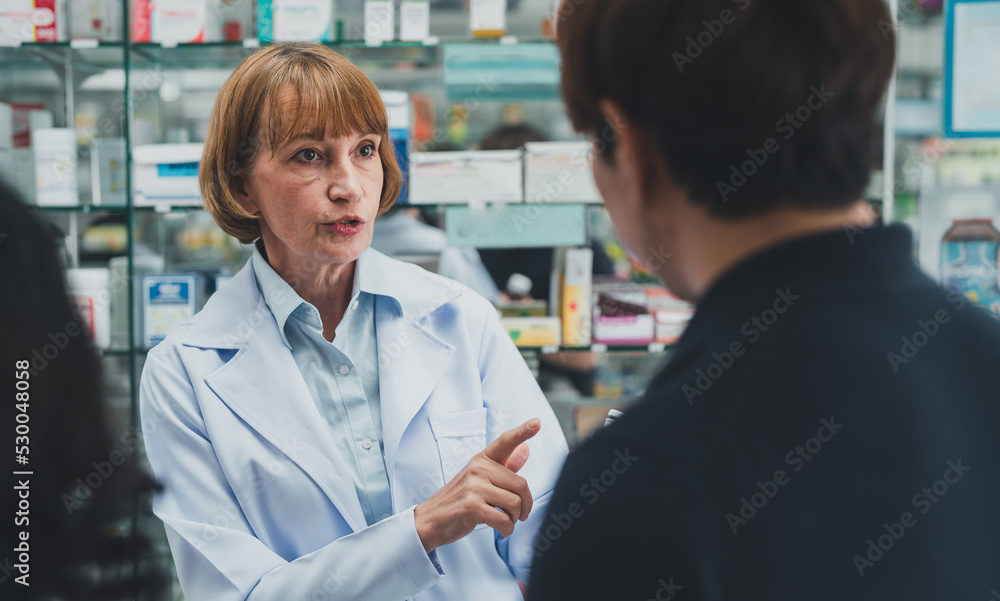 Fototapeta premium Pharmacists provide drug advice to male customers.female doctor healt care of pharmacy customer health.doctor giving prescription.