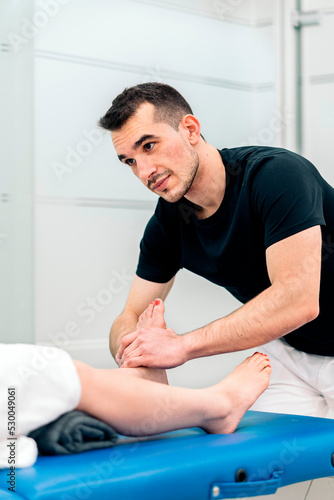 Physiotherapist Massaging Woman's Feet © santypan