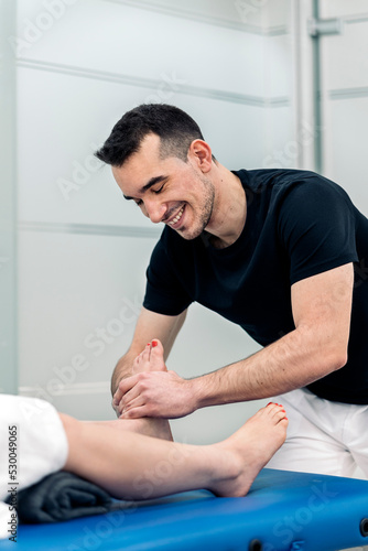 Physiotherapist Massaging Woman's Feet
