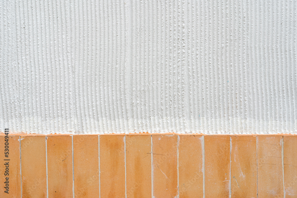 Fototapeta premium White vertical stripe plastered wall. Structural plaster on wall