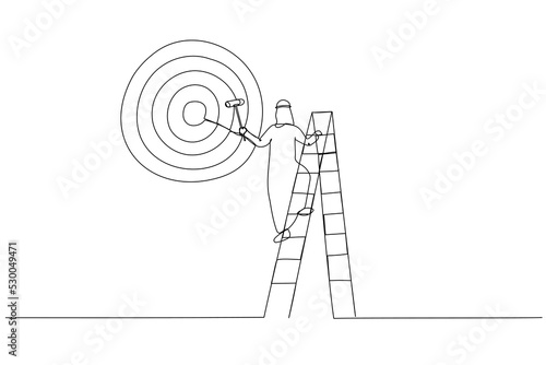 Drawing of ambitious arab businessman on ladder using paint roller to paint big dartboard, archery target. Single continuous line art style