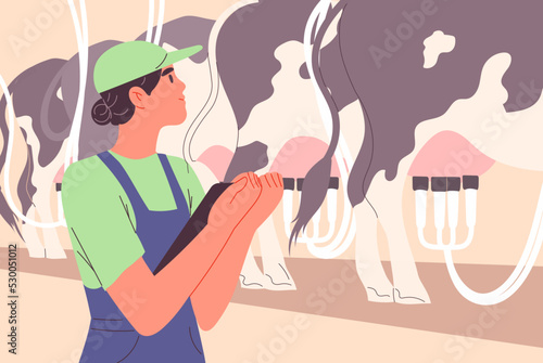 Farm worker inspects automatic milking of cows