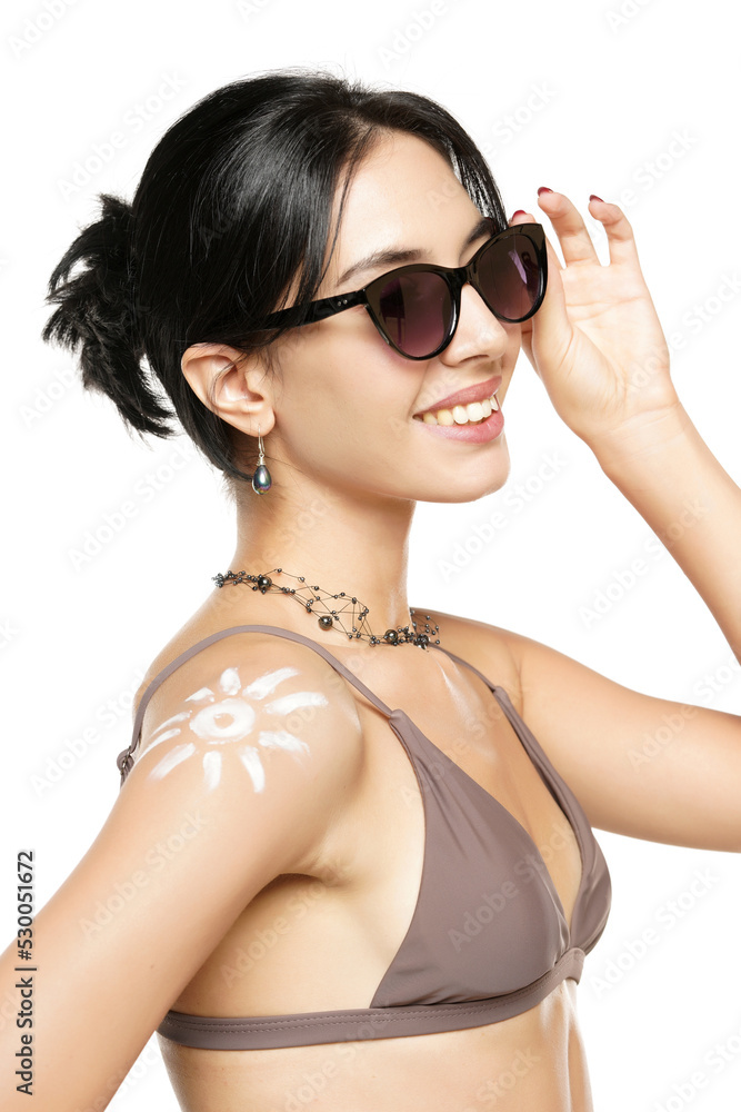 Happy Woman In Bikini With Suntan Lotion Shaped Sun On Her Shoulder, On A White Background. Happy Woman In Bikini With Suntan Lotion Shaped Sun On Her Shoulder, On A White Background.