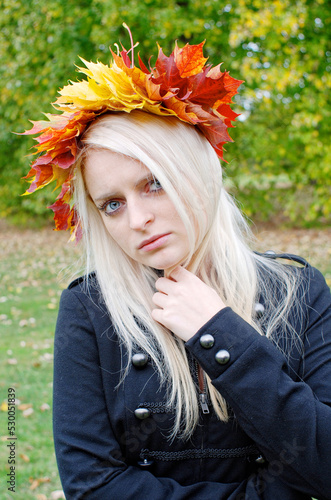 Woman with leaves crown autumn symbol outdoor