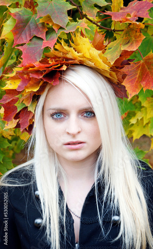 Portrait of a beautiful woman with autumn leaves