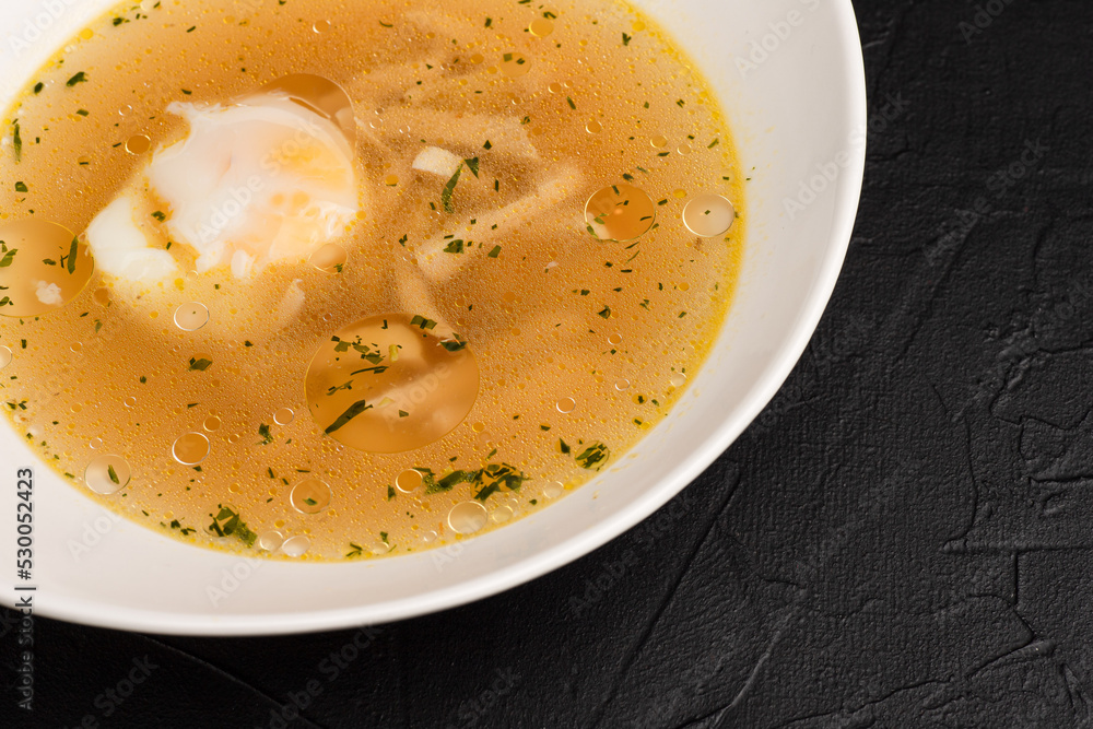 Chicken soup, chicken soup on a black background side view Chicken soup, chicken soup on a black background side view