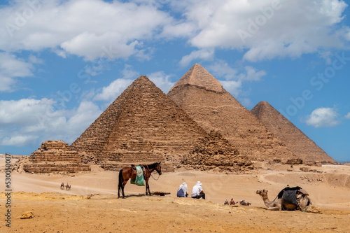 Cairo  Egypt. 08.25.2022. Group of tourists watching the Panoramic view of the pyramids of Micerino  Kefren and Cheops.