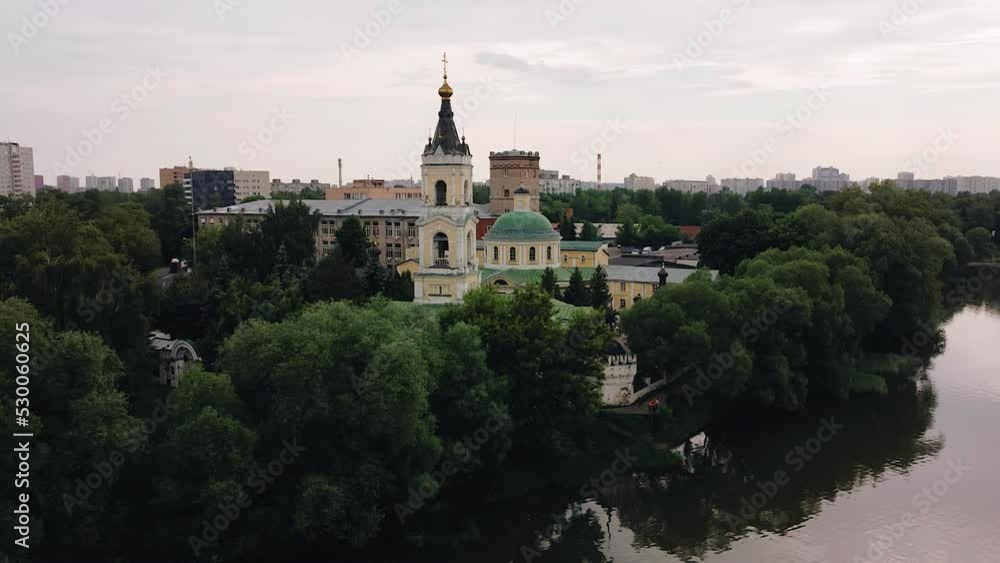 The Christian church is located on the shore of the lake surrounded by trees. Quadrotor filming The Christian church is located on the shore of the lake surrounded by trees. Quadrotor filming