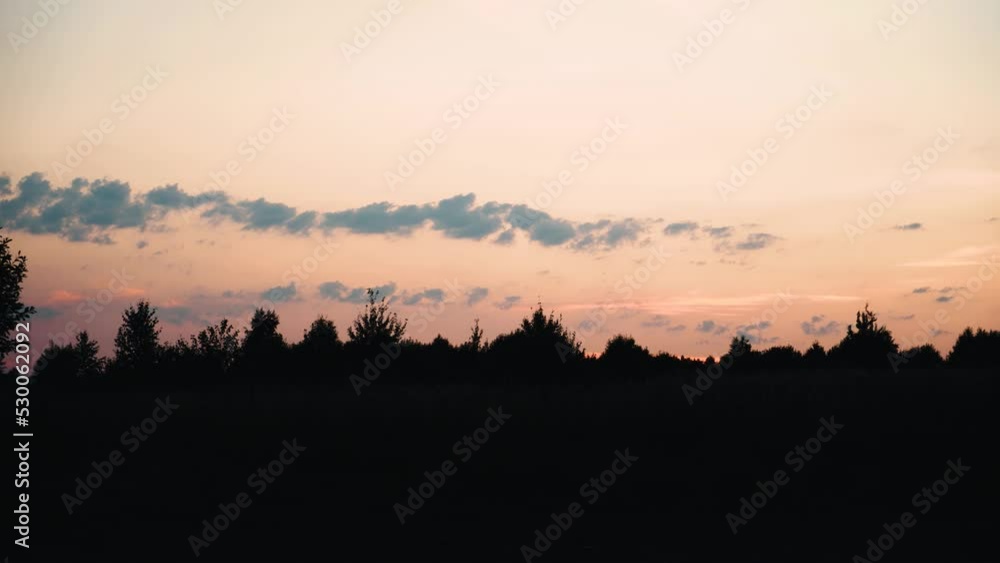Beautiful sunset sky and the outlines of trees in the distance. Shooting outside the city away from civilization in the evening. Beautiful sunset sky and the outlines of trees in the distance. Shooting outside the city away from civilization in the evening.