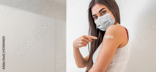 Portrait of young adult woman, getting her immunity shot.
