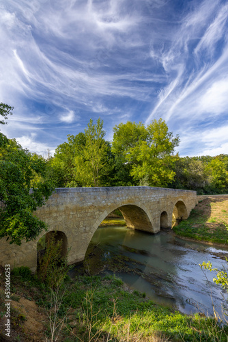 Romanesque bridge of Artigue and river Osse near Larressingle on route to Santiago de Compostela, UNESCO World Heritage Site, departement Gers, France photo