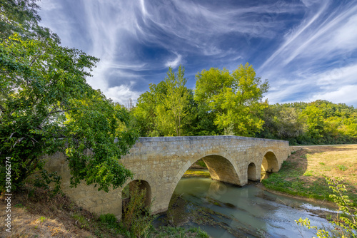 Romanesque bridge of Artigue and river Osse near Larressingle on route to Santiago de Compostela, UNESCO World Heritage Site, departement Gers, France photo