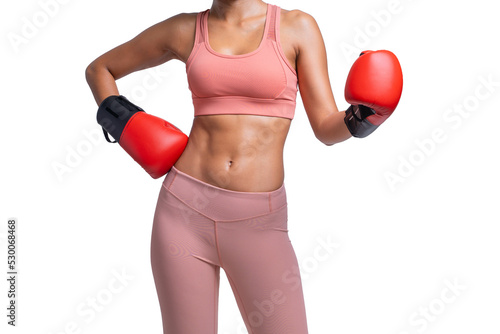 close up of Fitness woman in pink sportswear with red boxing mitts showing abs and flat belly, In selective focus of Abdominal muscle © Jirus