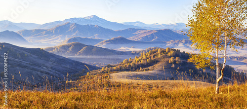 Beautiful panoramic view of autumn nature. Mountain landscape, morning haze.