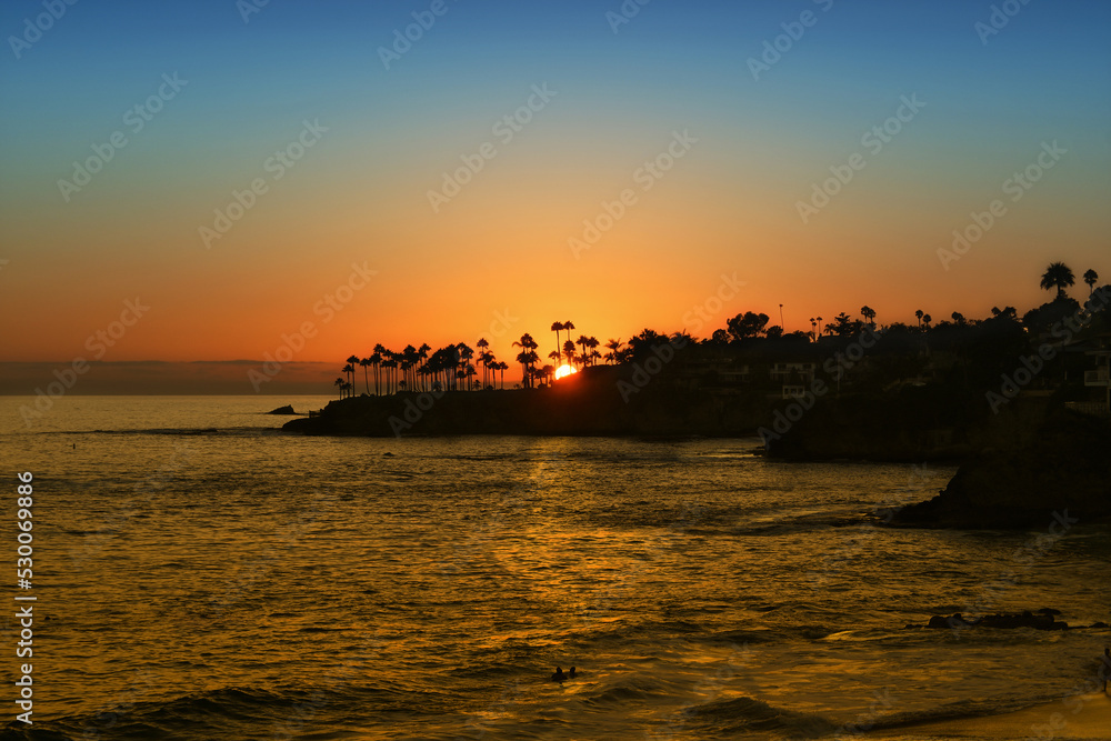 Sun Setting behind Twin Points, Laguna Beach, California, looking over Fishermans Cove, Shaws Cove and Divers Cove.