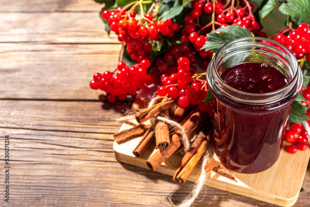 Autumn jam recipe, conservation and harvest season. Homemade red jam from organic viburnum berries, with fresh berries on twigs and cinnamon Autumn jam recipe, conservation and harvest season. Homemade red jam from organic viburnum berries, with fresh berries on twigs and cinnamon