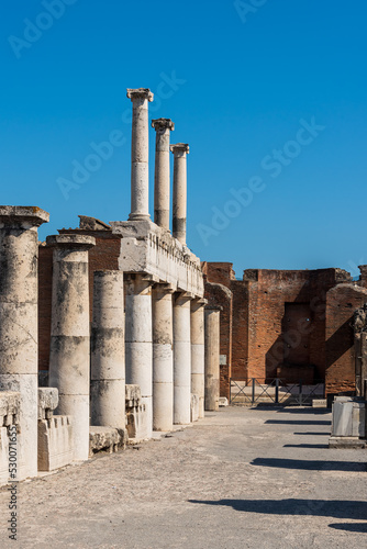 Exterior facade in ruins of old roman temple in Pompeii viewed in perspective