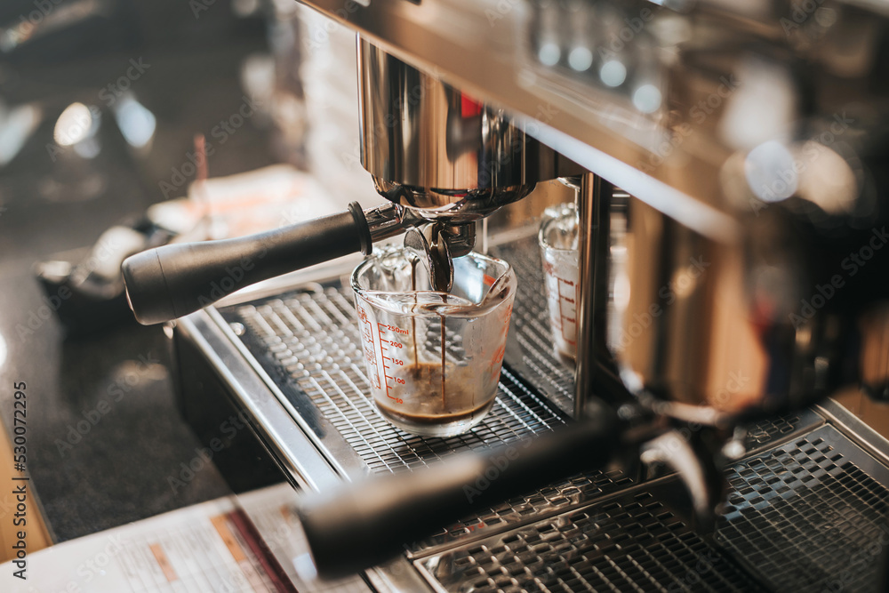 Making fresh coffee from espresso machine. preparing hot espresso coffee by automatic coffee machine in counter coffee shop. Making fresh coffee from espresso machine. preparing hot espresso coffee by automatic coffee machine in counter coffee shop.