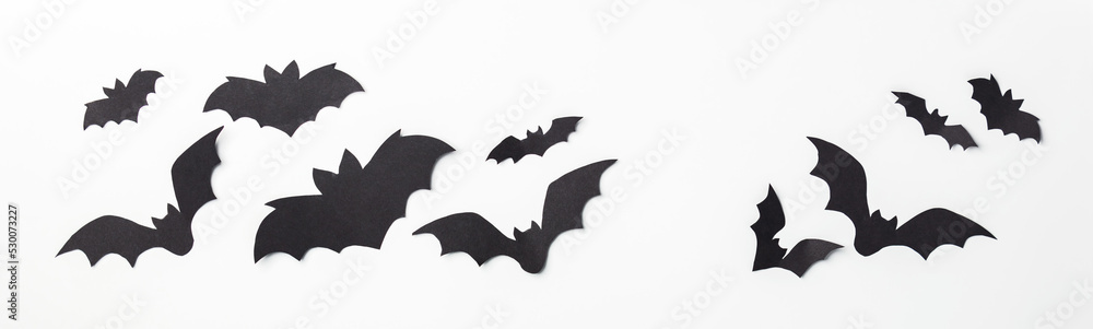 Fototapeta premium Halloween decoration concept - black paper bats and scary trees shadows background, banner