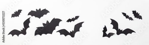 Fotografiet Halloween decoration concept - black paper bats and scary trees shadows backgrou