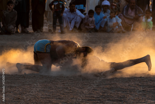 people of rural areas of punjab are playing a traditional wrestling "kabaddi", Kabaddi is a contact team sport. Played between two teams of seven players, a famous rural sport in India and Pakistan 