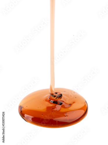 Caramel syrup drizzle isolated on white background. Splashes of sweet caramel sauce.