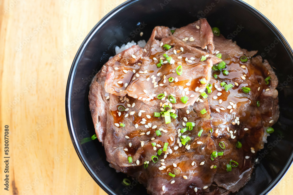 Wagyu beef Donburi with Japanese rice in black bowl. Wagyu beef Donburi with Japanese rice in black bowl.