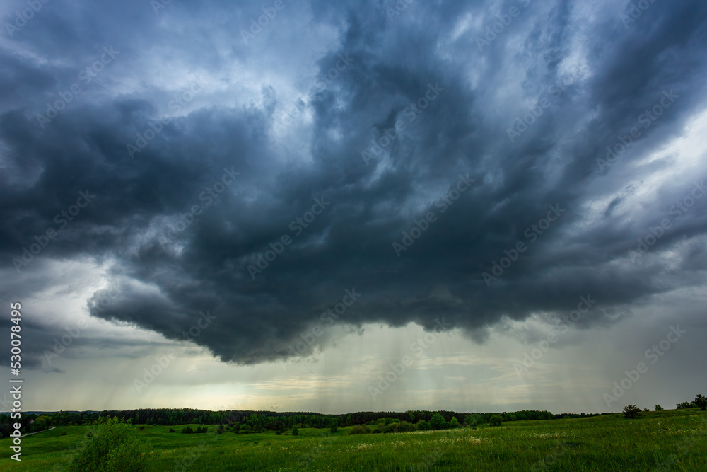 Storm clouds over field, storm cell, extreme weather, dangerous storm Storm clouds over field, storm cell, extreme weather, dangerous storm