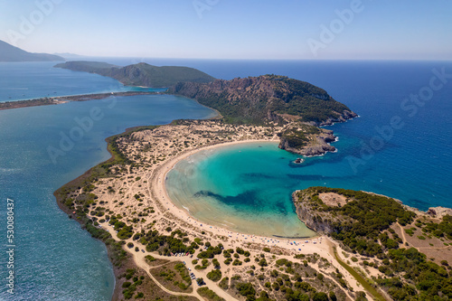 Aerial drone photo of the iconic semicircular sandy beach of Voidokoilia in Messinia, Gialova, Peloponnese, Greece