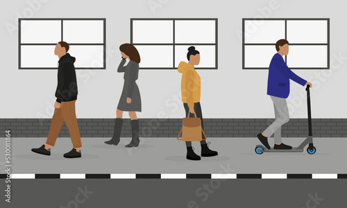 People move along the sidewalk in different directions against the background of a wall with windows