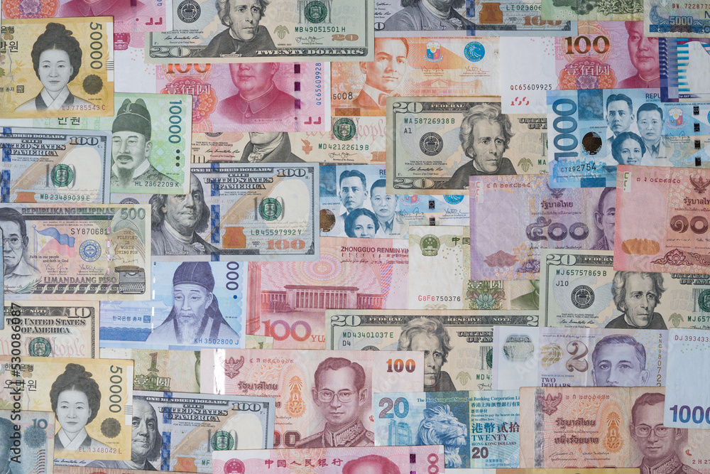Closeup of variety banknote around the world include dollar Yuan Baht Peso Won for currency exchange or Forex investment and money payment transfer concept. - obrazy, fototapety, plakaty 