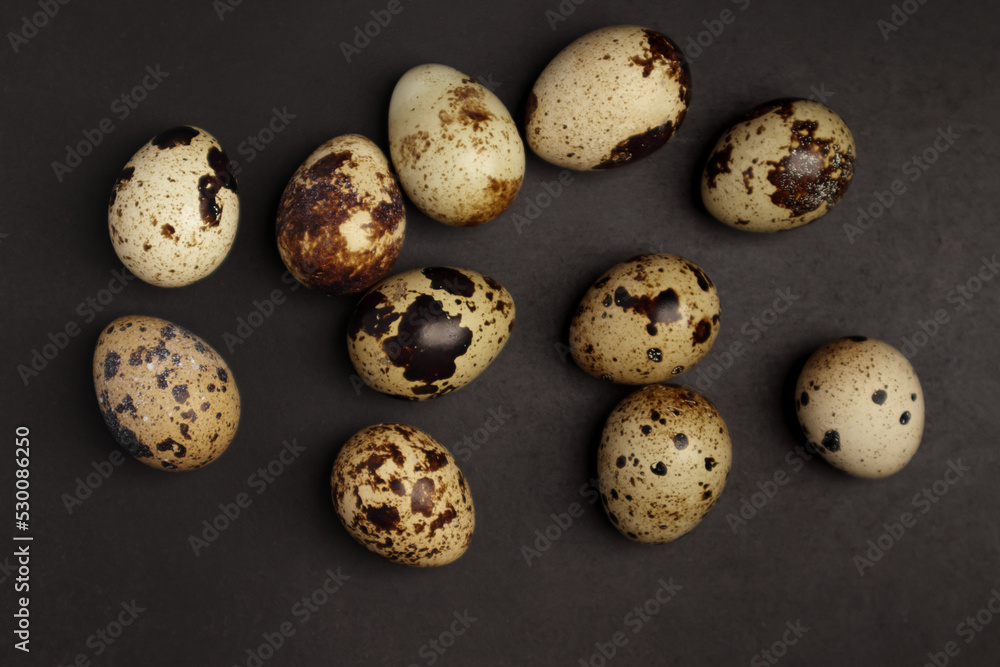 Quail eggs on black background. Healthy food concept. Top view Quail eggs on black background. Healthy food concept. Top view