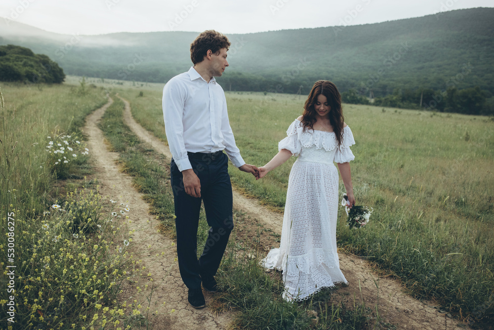 Young smiling wedding couple in nature. Happy bride and stylish groom. Wedding. High quality photo