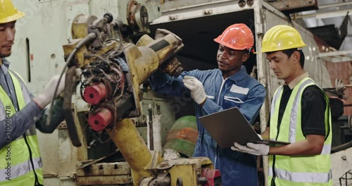 Group of machine technicians are profession inspect the electrical equipment in factory. Industrial plant engineers plan machine maintenance. African American workers work with Asian team Blue collar