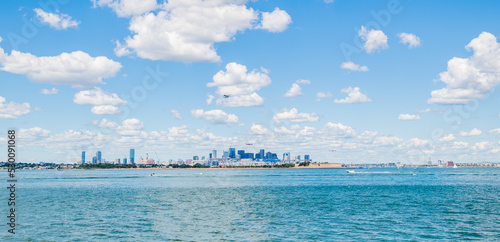 Wide panoramic view of sea plane in the air flying over the Atlantic Ocean and Boston Harbor. © Michael Moloney