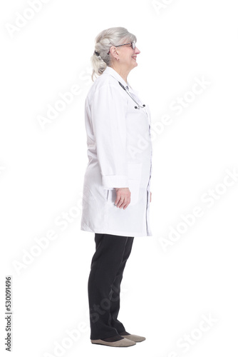 smiling woman doctor reading an ad on a white screen.