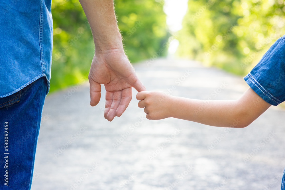 A Hands of happy parent and child on nature on the road in park background A Hands of happy parent and child on nature on the road in park background